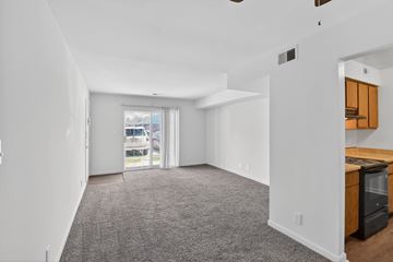 Evansville apartment for rent - A spacious living room with a grey carpet and white walls.