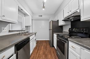 Jackson apartment for rent - A kitchen with white cabinets and stainless steel appliances.