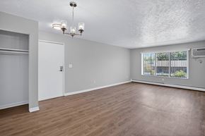 Battle Creek apartment for rent - A room with a door and a window with a view of a fence and trees.