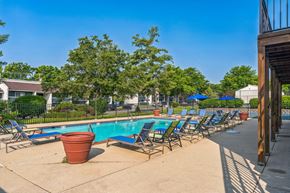 Lexington apartment for rent - A pool area with chairs and a potted plant.