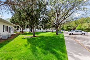 Springfield apartment for rent - a white car parked in front of a house with trees