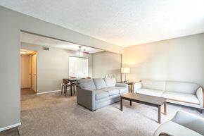 Lexington apartment for rent - A living room with a grey couch, a white couch, and a brown coffee table.