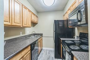 Lexington apartment for rent - A kitchen with black appliances and wooden cabinets.