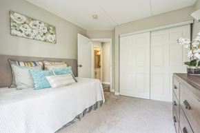 Gurnee apartment for rent - A bedroom with a bed, dresser and a painting on the wall.