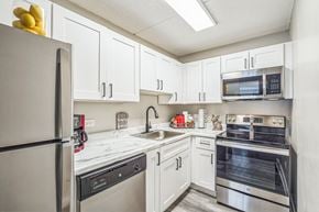 Gurnee apartment for rent - A kitchen with white cabinets and stainless steel appliances.