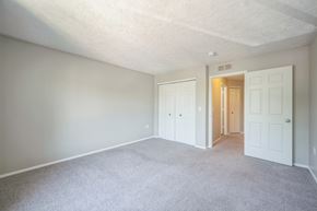 Fenton apartment for rent - A room with white walls and carpeted floor with two doors.