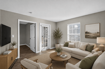 Louisville apartment for rent - A living room with a white couch, a wooden coffee table, and a television on a cabinet.