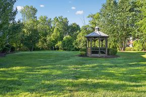 Louisville apartment for rent - A gazebo sits in the middle of a lush green field.