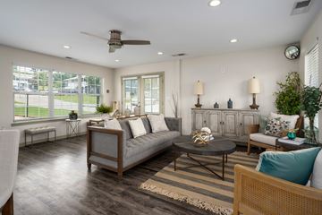 Prattville apartment for rent - A living room with a grey couch and a wooden coffee table.