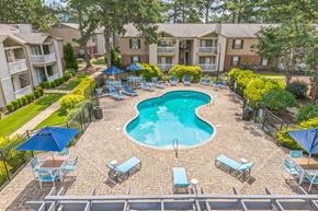 Mobile apartment for rent - Resort-style pool with chairs and umbrellas at Ashford Place Mobile AL