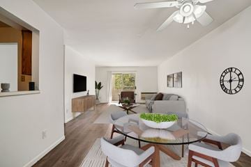Madison apartment for rent - A modern living room with a glass table and white chairs.