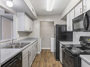 Montgomery apartment for rent - Kitchen with white cabinets and black appliances at Park at Meadow Ridge Montgomery AL