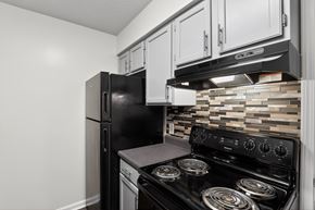 Evansville apartment for rent - A black refrigerator and stove in a kitchen.