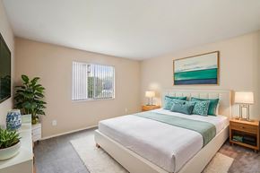 Westland apartment for rent - A bedroom with a large bed and a painting on the wall.