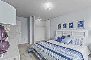 Springfield apartment for rent - a bedroom with a bed and white walls and blue and white bedding