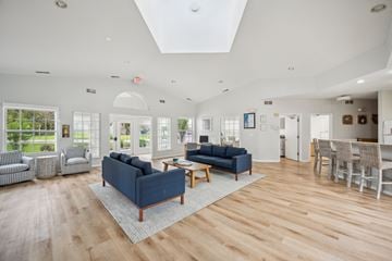 Westland apartment for rent - A spacious living room with a blue sofa and wooden flooring.
