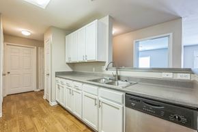 Prattville apartment for rent - A kitchen with white cabinets and a stainless steel dishwasher.
