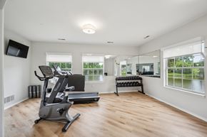 Westland apartment for rent - A spacious room with a treadmill and a television.