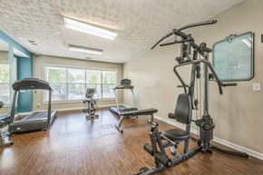 Prattville apartment for rent - A home gym with a treadmill, elliptical trainer, and a stationary bike.