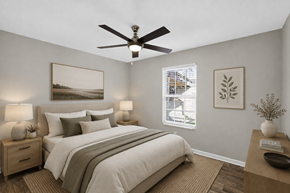 Louisville apartment for rent - A bedroom with a bed, nightstands, and a ceiling fan.