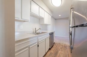 Richmond apartment for rent - A kitchen with white cabinets and a stainless steel refrigerator.