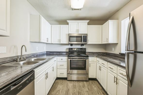 Prattville apartment for rent - A kitchen with white cabinets and stainless steel appliances.