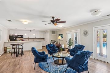 Spartanburg apartment for rent - A living room with blue chairs and a ceiling fan.