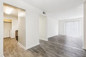 Mobile apartment for rent - A room with a wooden floor and white walls.