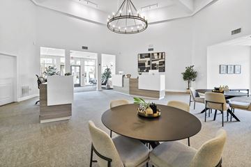 Carrollton apartment for rent - A modern living room with a round table and chairs.