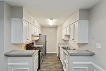 Jackson apartment for rent - A kitchen with white cabinets and a grey countertop.