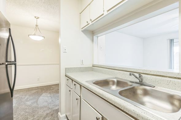 Mobile apartment for rent - A kitchen with a sink and a refrigerator.