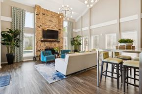 Mobile apartment for rent - A living room with a fireplace and a blue chair.
