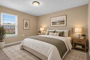 Millbrook apartment for rent - A bedroom with a large bed and a window overlooking a house.