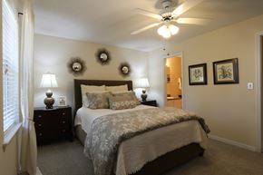 Macon apartment for rent - a bedroom with a large bed and a ceiling fan