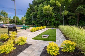 Outdoor recreation area with cornhole - the foundry carrollton - professionally operated by highlands vista group