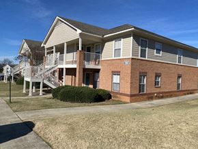 Millbrook apartment for rent - the front of a brick house with a porch and stairs