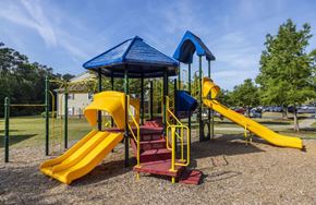 Augusta apartment for rent - a playground with a yellow and blue slide and monkey bars