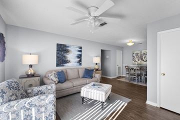 Flowood apartment for rent - A living room with a couch, chair, and a painting on the wall.