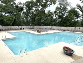 Cedar Rapids apartment for rent - a swimming pool with chairs around it