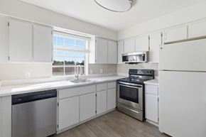 Tallahassee apartment for rent - A kitchen with white cabinets and stainless steel appliances.