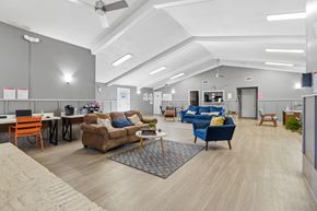 Tallahassee apartment for rent - A spacious office with a variety of seating options and a modern design.