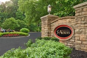 Louisville apartment for rent - a sign on a stone wall at the entrance to a starbucks shareholders sign