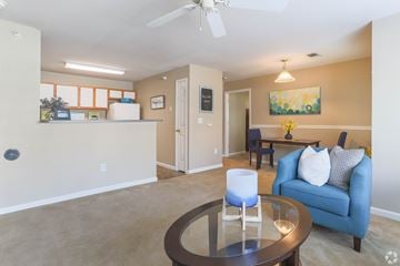 Lincoln apartment for rent - A living room with a blue couch and a glass table.