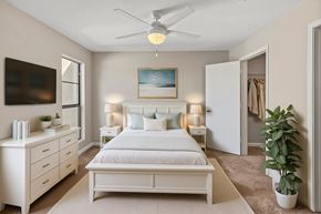 Lake Charles apartment for rent - A bedroom with a bed, dresser, and ceiling fan.
