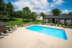 Saint Joseph apartment for rent - A large outdoor swimming pool surrounded by lounge chairs and trees.