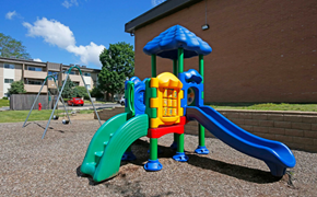 Peoria apartment for rent - A playground with a blue slide and a yellow and red structure.