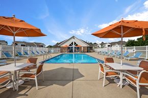 Muskegon apartment for rent - Resort-style pool and seating area at Arbor Crossings Muskegon MI
