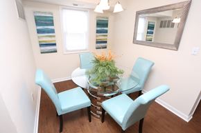 Evansville apartment for rent - a small dining room with a glass table and blue chairs