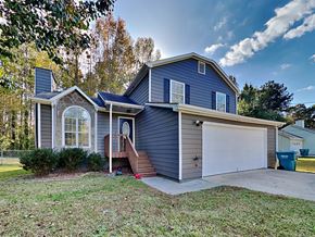 Hampton house for rent - a blue house with a white garage door