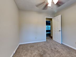 Hampton house for rent - a bedroom with a white door and a ceiling fan